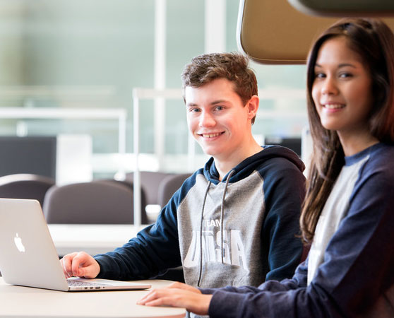 Young High School students at a laptop computer