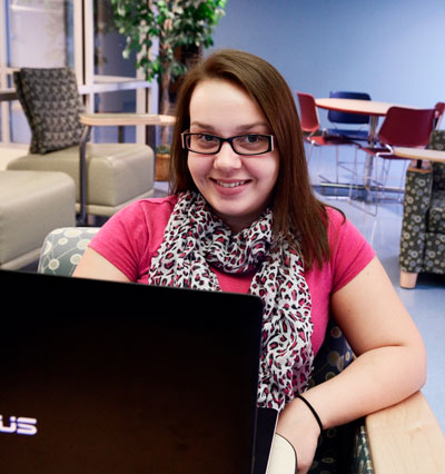 Fulton student on a laptop studying