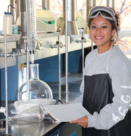 Student in chemistry lab smiling