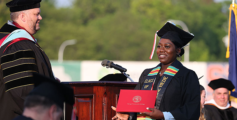 Graduating Cayuga student accepting her diploma on stage