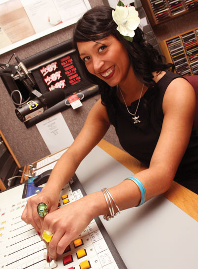 Telcom student working the control board in the college radio station