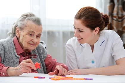 Nursing student helping an elderly woman